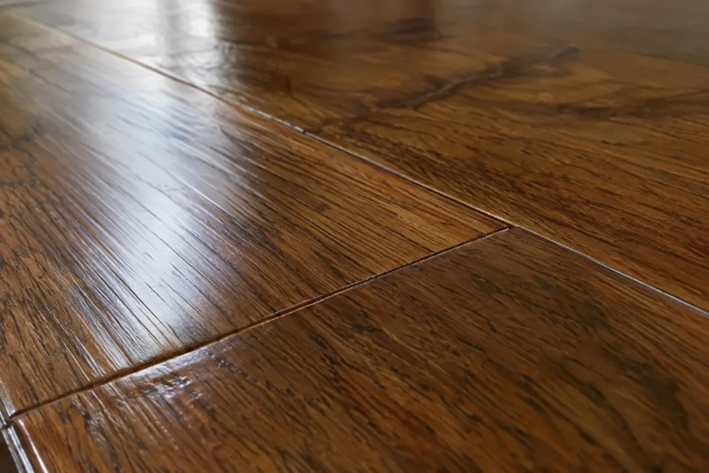 Close-up of prefinished hardwood flooring showing beveled seams between planks