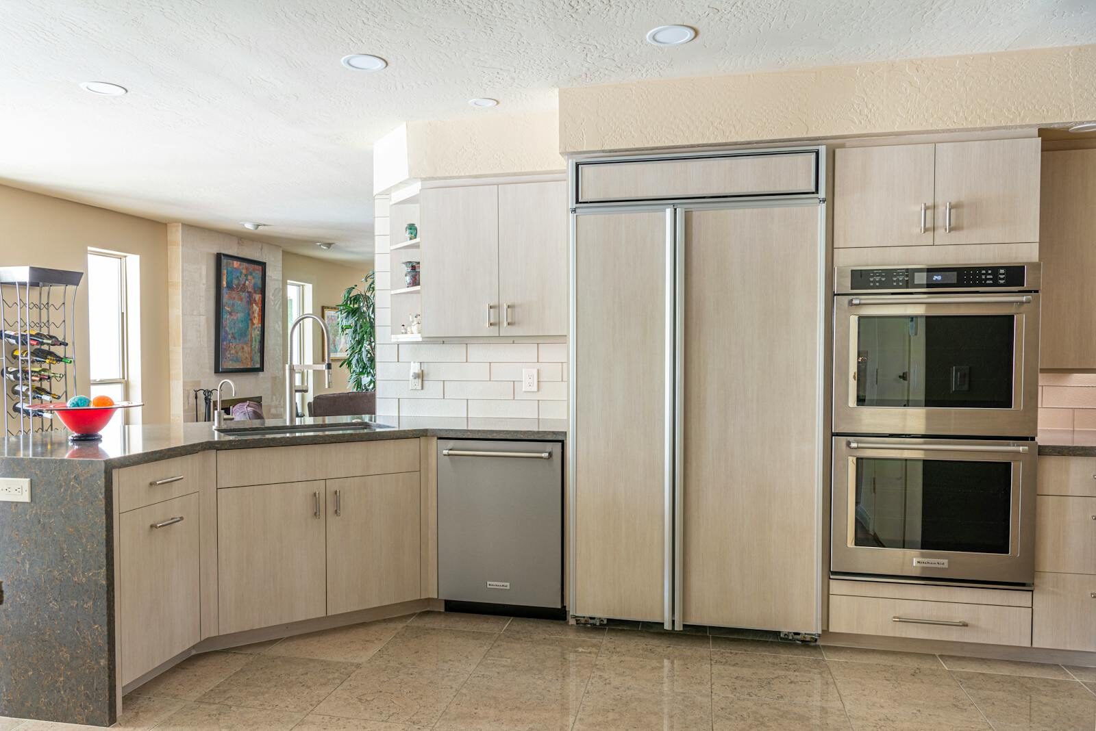 Spacious kitchen with sleek cabinets, stainless steel appliances, and elegant countertops.