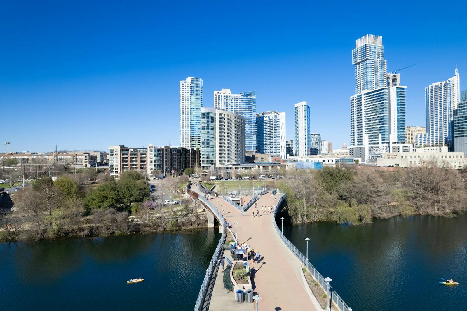 Stunning aerial view of Austin's modern skyline with a scenic riverfront bridge.