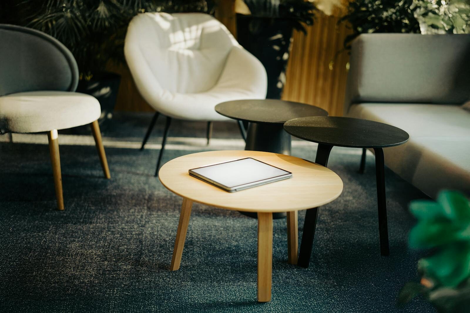 Stylish interior scene featuring a digital tablet on a coffee table in a cozy living room setting.