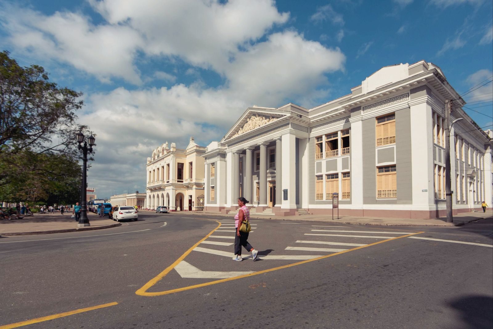 View of neoclassical buildings in Santa Clara with people crossing the street.