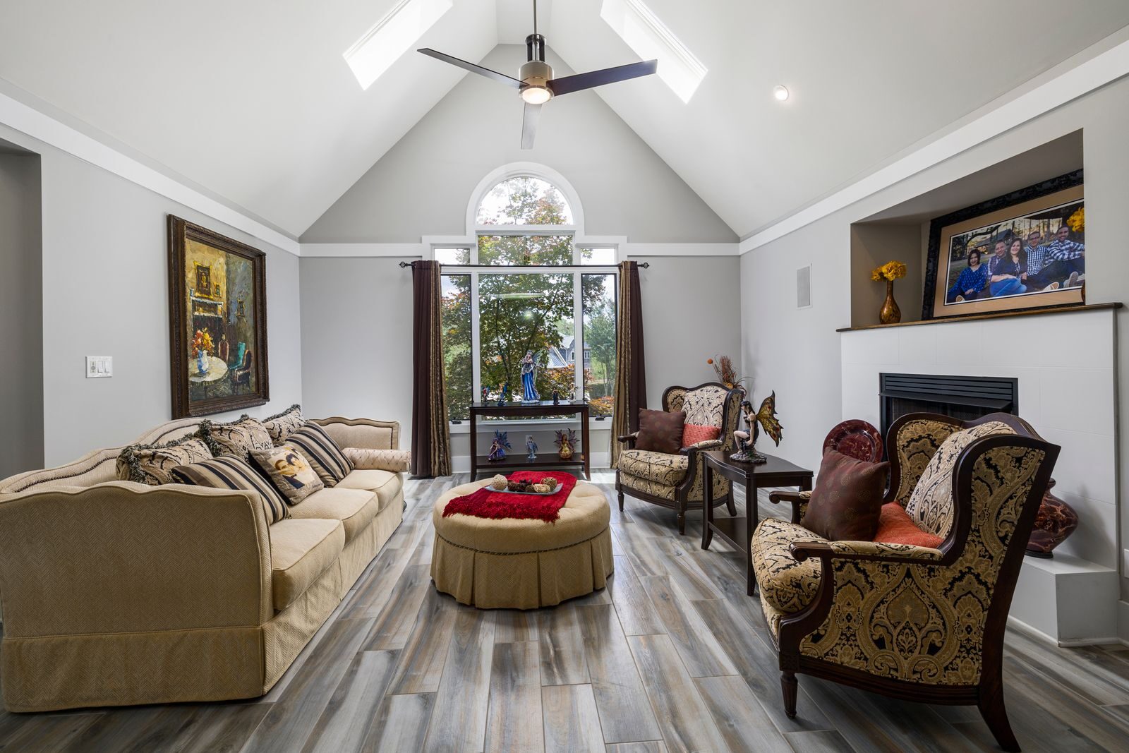 Spacious living room with elegant traditional furniture and large window.