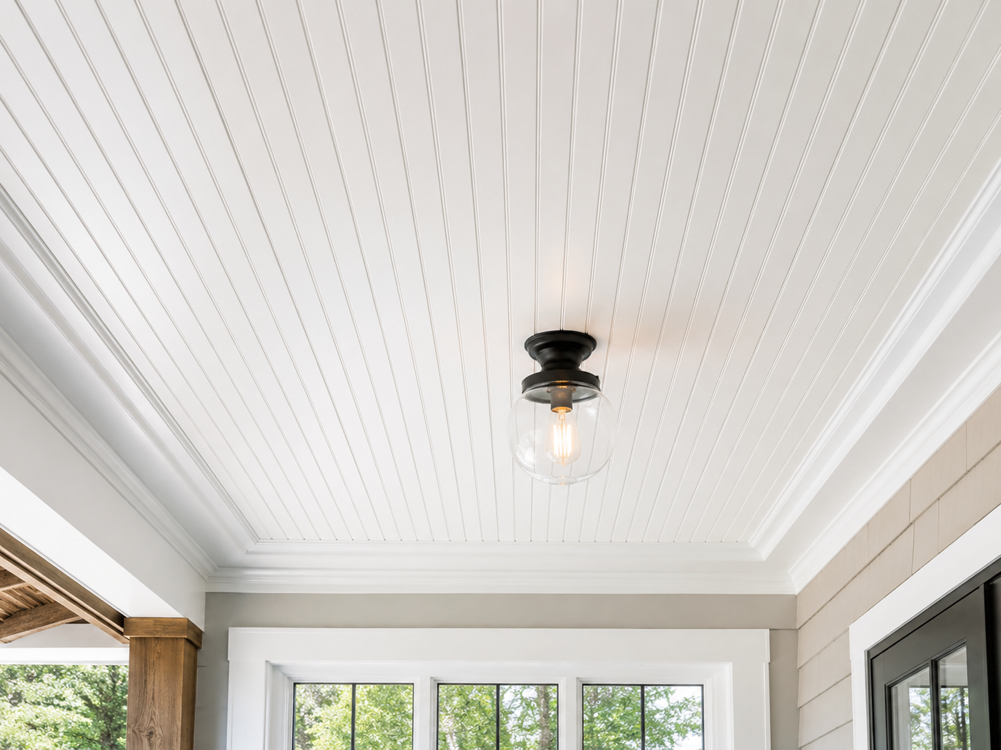 "Elegant white beadboard ceiling with classic panel detailing, crown molding, and modern light fixture in a bright residential interior, showcasing timeless farmhouse and coastal ceiling design."