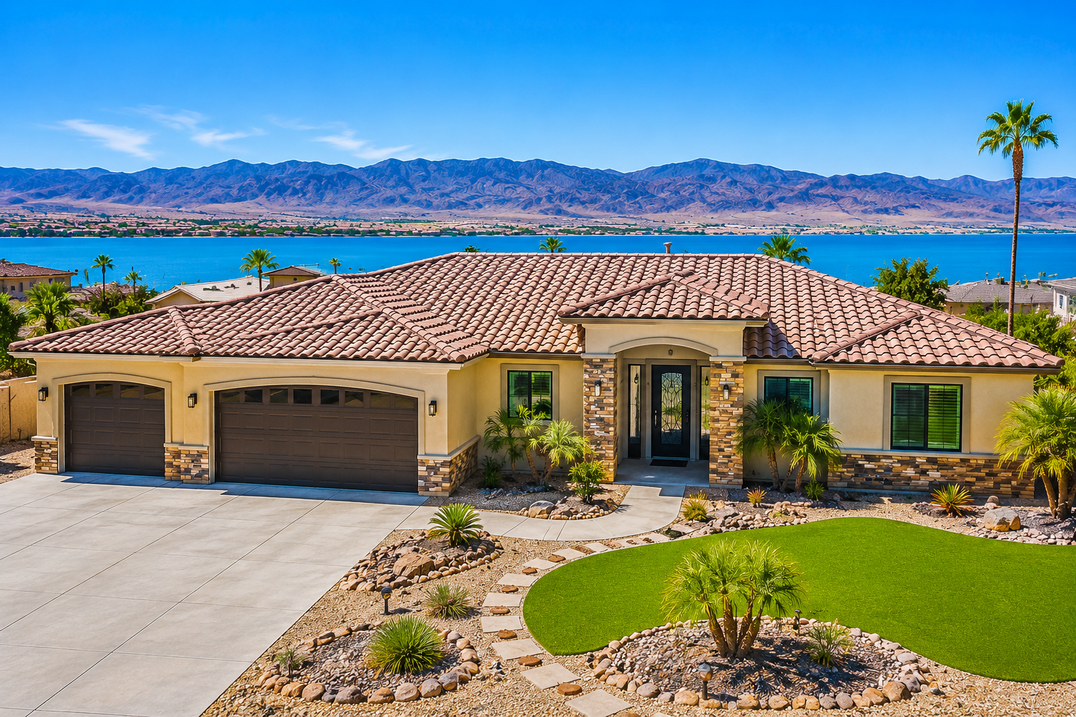 "Luxury 4-bedroom home at 635 Sand Dab Dr in Lake Havasu City featuring stunning lake views, desert landscaping, a three-car garage, and modern Southwestern architecture under a clear blue sky."