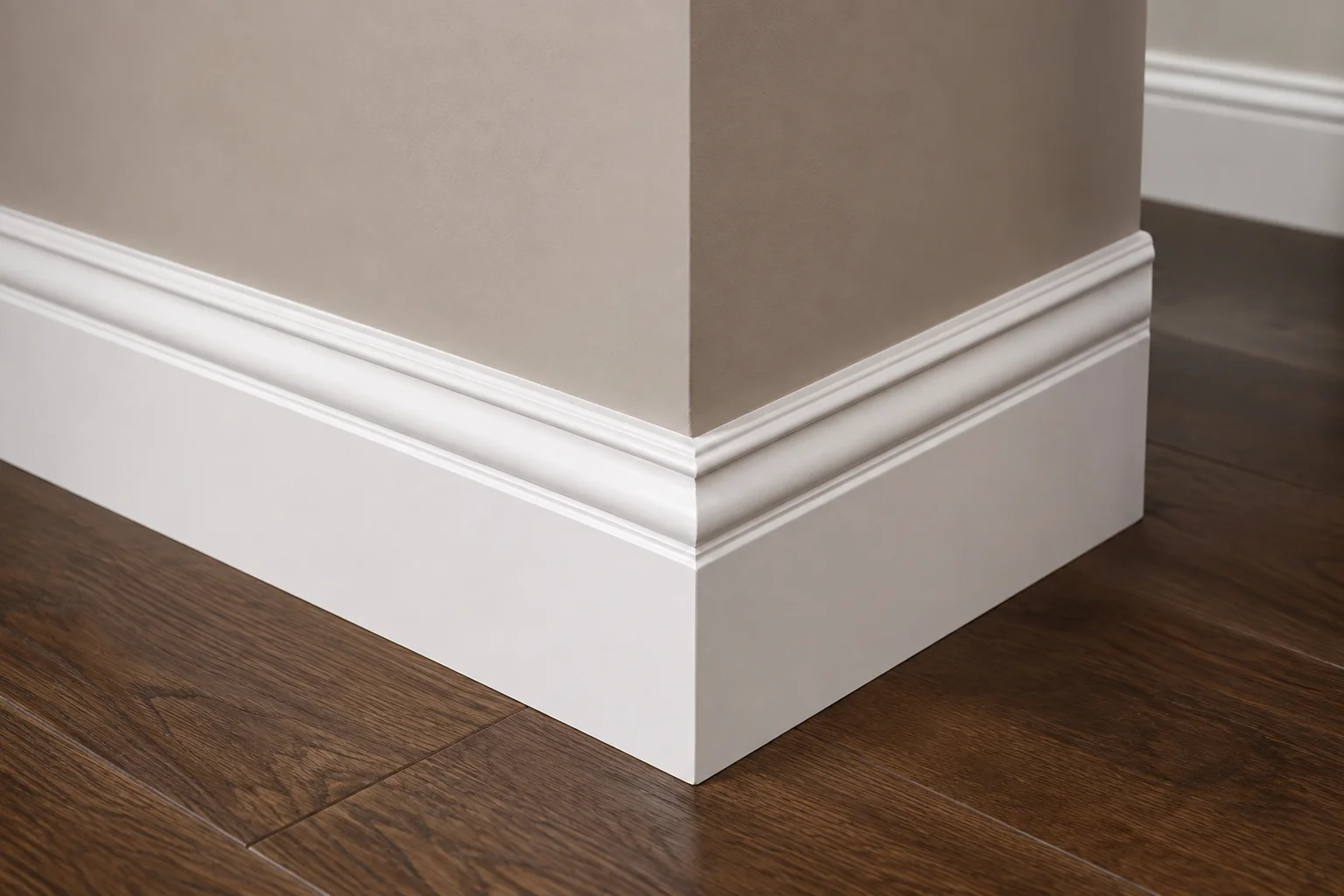 shoe molding installed along a white baseboard and dark hardwood floor in a modern interior corner.