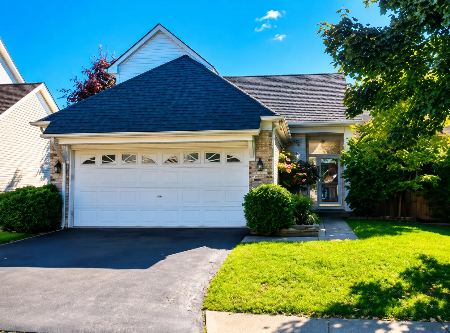 24450 Indoplex Circle in Farmington Hills, Michigan, showing a residential-style property exterior with a two-car garage and landscaped front yard