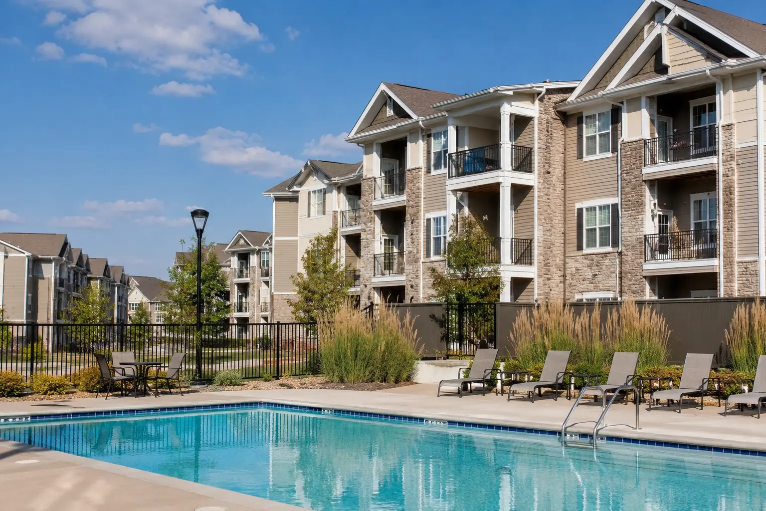 Modern apartment community with resort-style swimming pool and landscaped grounds in Clarksville, Tennessee.
