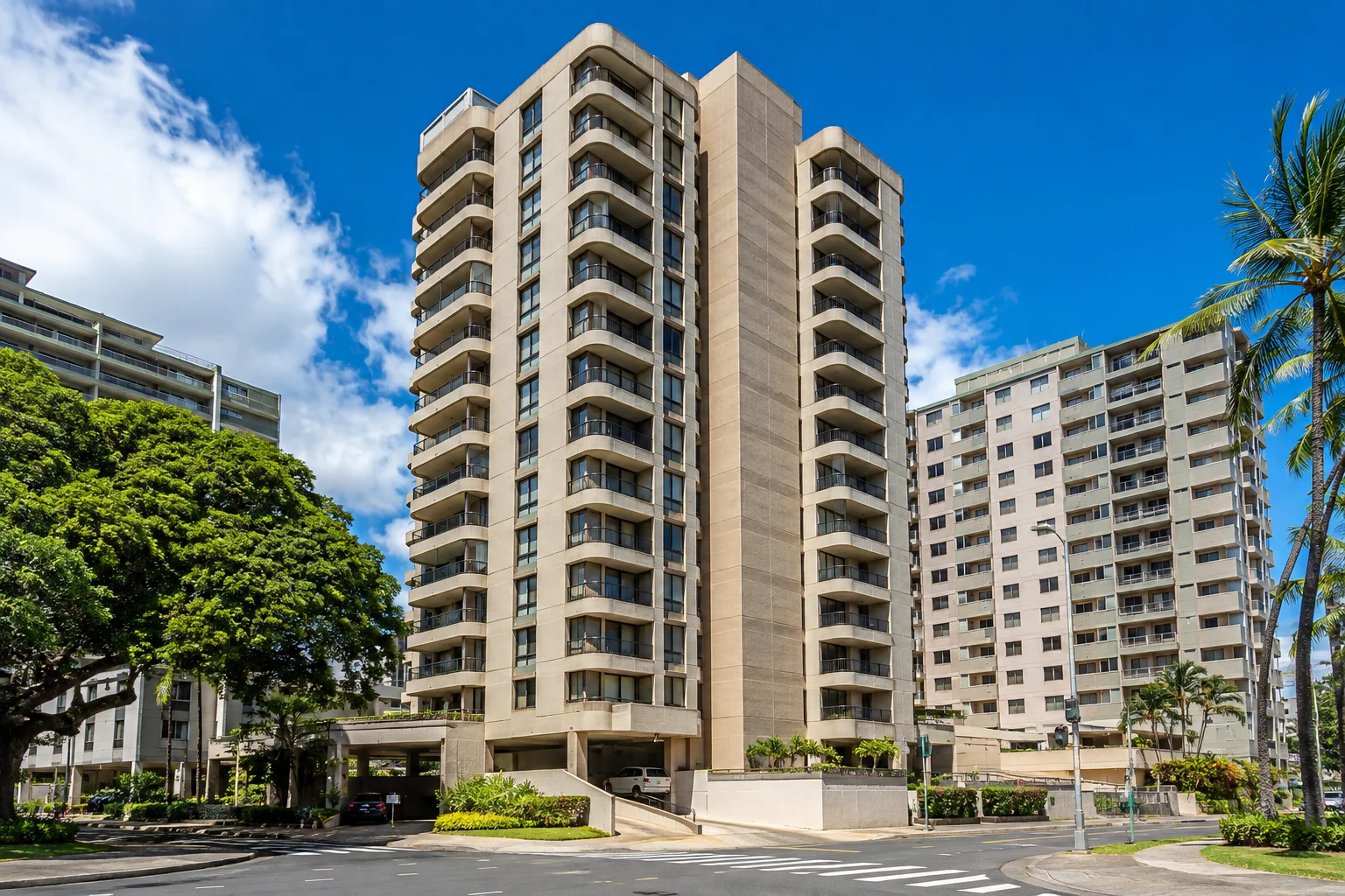 Coty Towers condominium building in Honolulu, Hawaii, featuring modern balconies, tropical landscaping, and a bright urban setting.