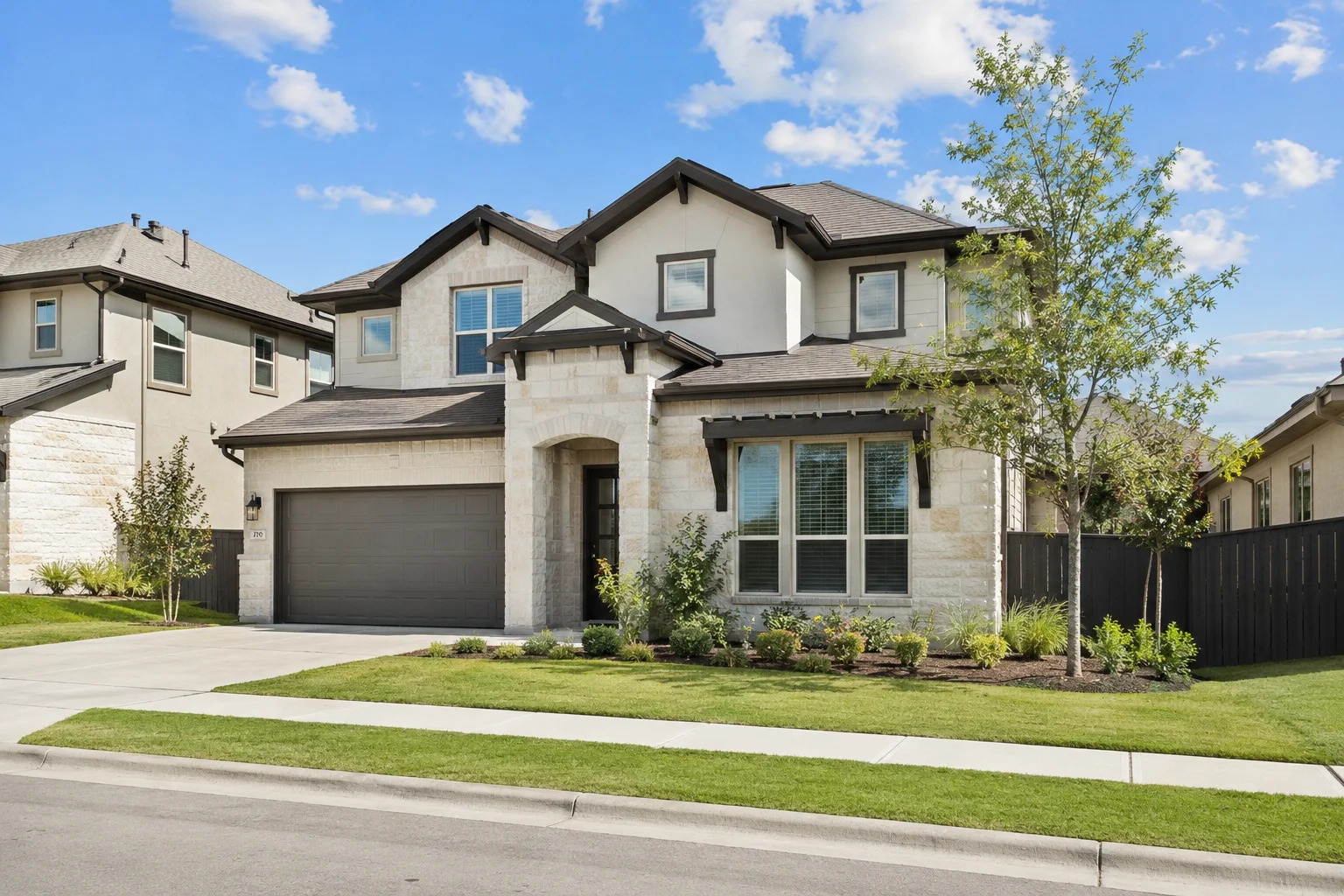 Springdale Creek Austin TX home with stone exterior, landscaped yard, and welcoming entrance
