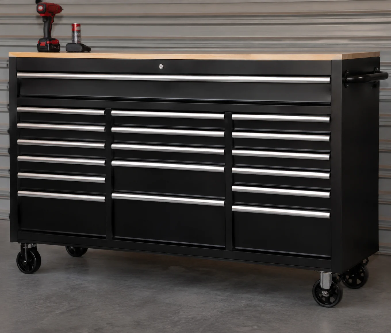 Realistic 17-drawer rolling tool cabinet with black metal finish, spacious drawers, sturdy casters, and wooden worktop in a modern garage workshop.