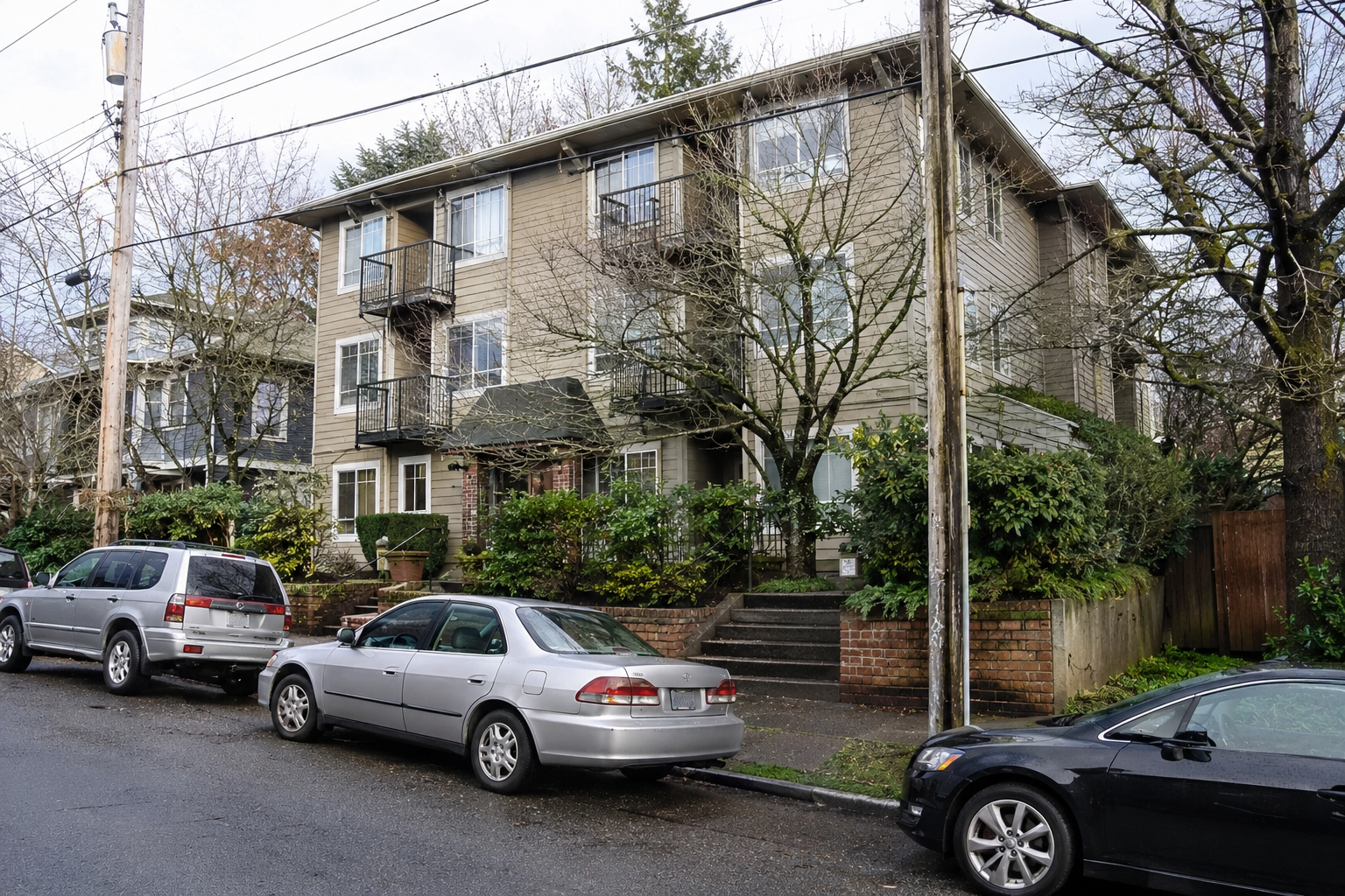 Keystone Apartments at 9208 20th Ave SW Seattle, featuring a realistic exterior view of the residential apartment building, balconies, landscaped entrance, and street parking.