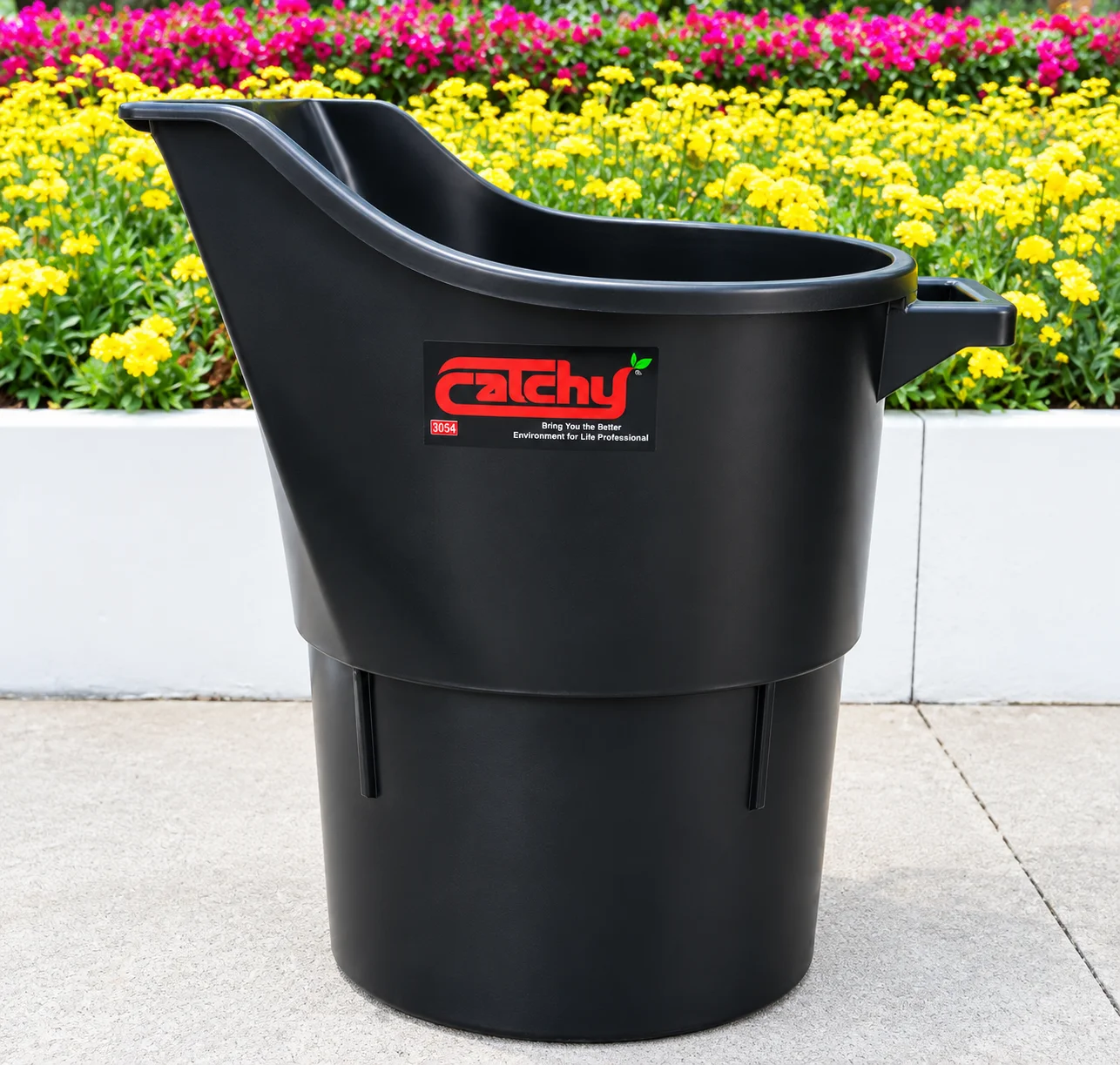 Catchy black commercial utility trash can with sloped opening in a colorful outdoor setting
