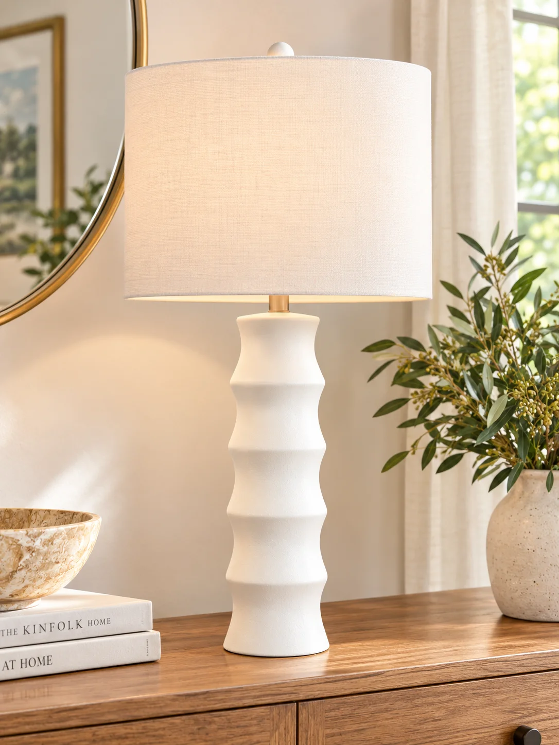 White scalloped Veraleigh table lamp by Ashley Furniture on a console table