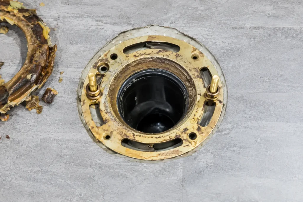 Clean toilet flange in a bathroom floor after the toilet has been removed