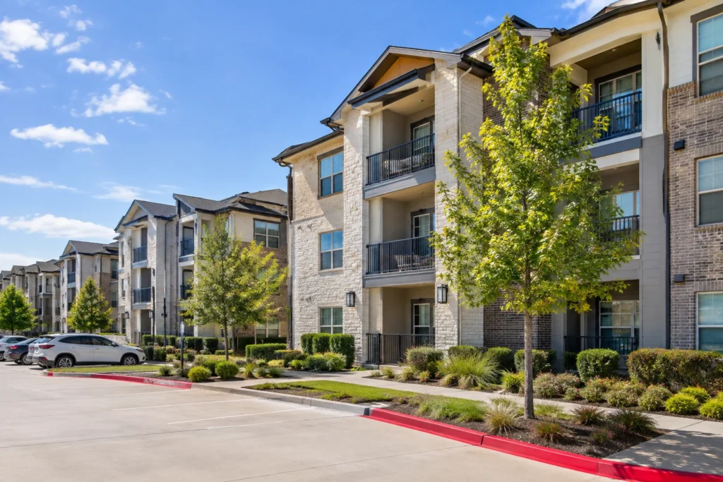 Exterior of a modern apartment community near Westlake, Texas, with landscaped walkways