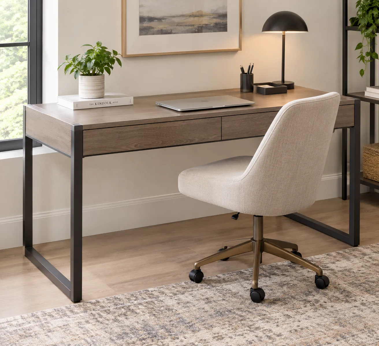 AI generated Illustration of Bowery Hill contemporary writing desk with a grayish ash wood finish, black metal frame, slim drawer, and minimalist decor in a bright modern home office with an upholstered chair and desk lamp